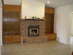 Large brick fireplace with shelves