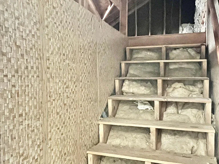 Stairway to attic unfinished room and lots of storage. Entrance from laundry/mud room