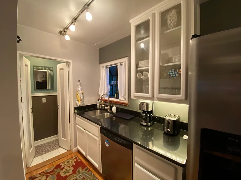 Partial view of kitchen, double door to powder/bathroom