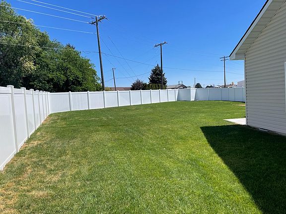 Large flat partially fenced-in yard