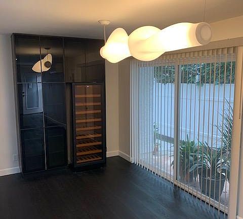 Dining area with large wine refrigerator.