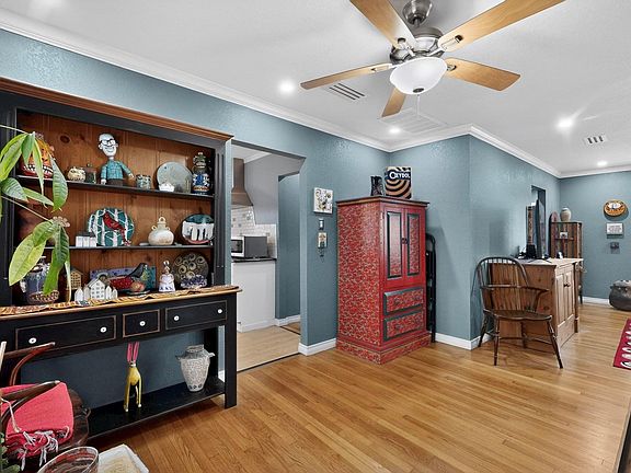A bright dining area with a ceiling fan
