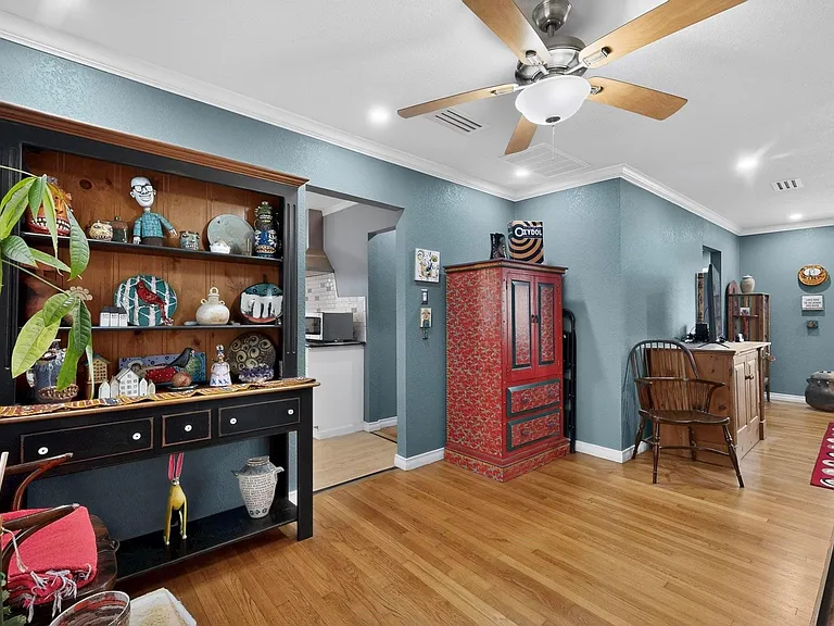 A bright dining area with a ceiling fan