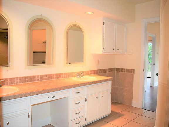 Master bath with double vanity and 2 walk-in closets