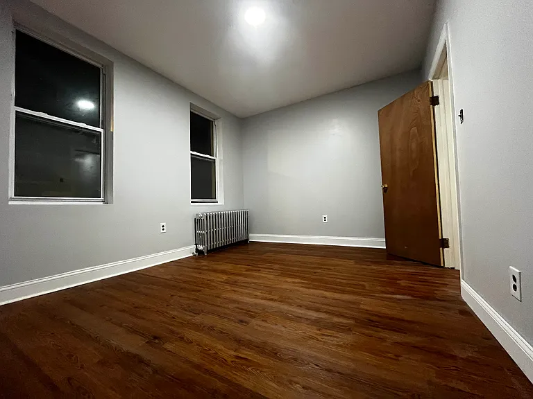 2nd bedroom with new laminate flooring and two windows