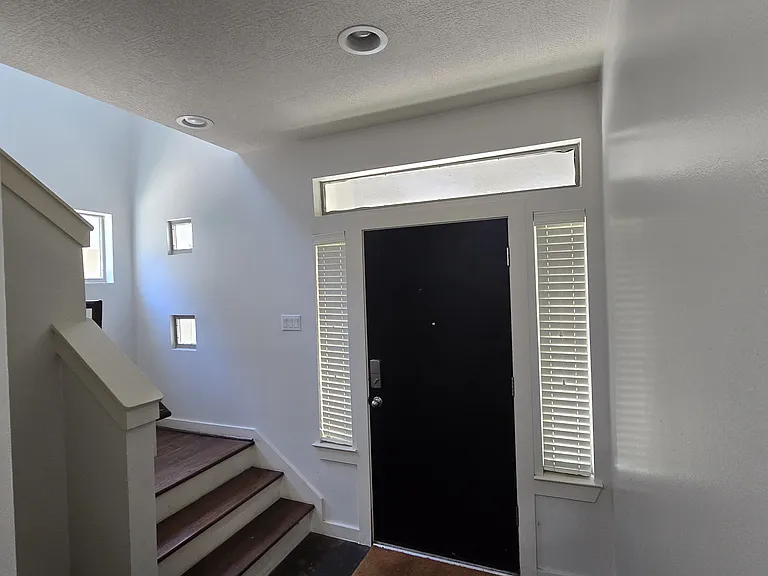 Main entrance to house. Upstairs is the master bedroom and living room with open kitchen. Downstairs has two bedrooms and a nice back yard.