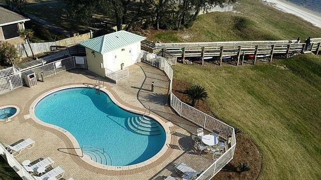 Pool and Hot Tub/Spa from 5th floor balcony. Well maintained landscaping and lots of green space.