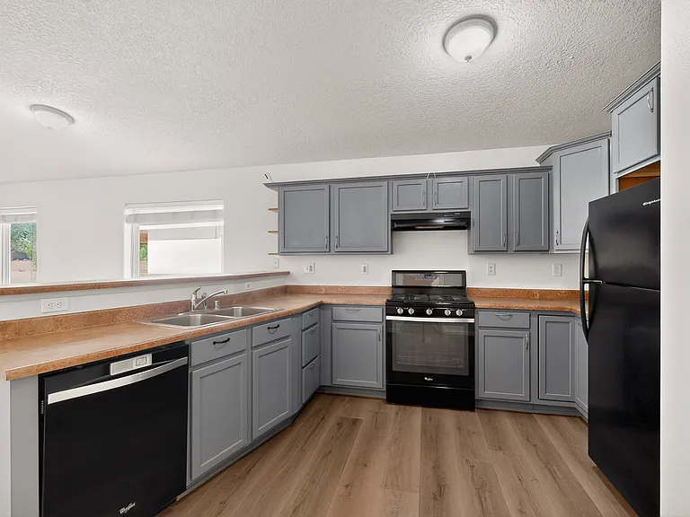 The kitchen features plenty of cabinet space, all the amenities you could ask for and bar-top seating space to bring the family together.