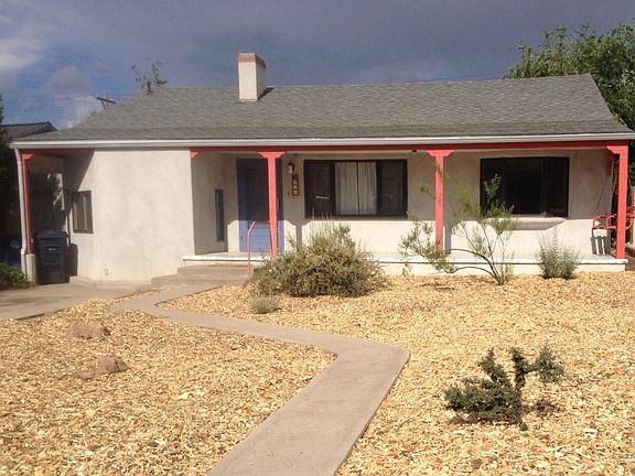 Xeriscaped front yard, covered porch.