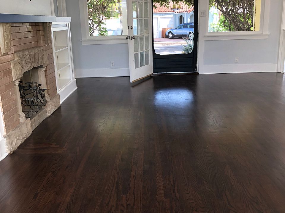 Living room with plentiful light, hardwood floors, front door