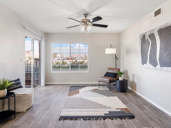 Pleasure in refined wood-style floors, sliding doors leading to your private patio, large windows, and a ceiling fan gracing our spacious living rooms.