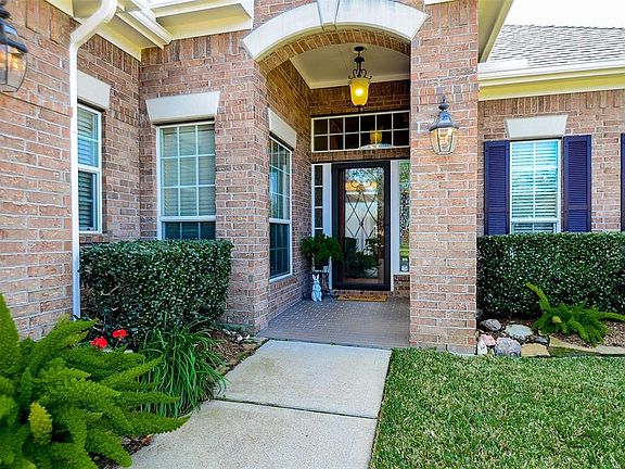 Great covered front porch with pretty archway. Notice the glass storm door with the solid mahogany door behind with leaded glass insert.