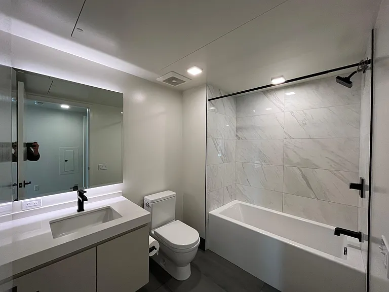 Bathroom with modern fixtures and deep bathtub