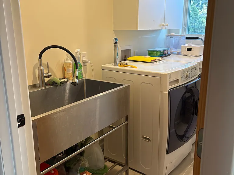laundry room with utility sink, cabinet, LG washer and dryer