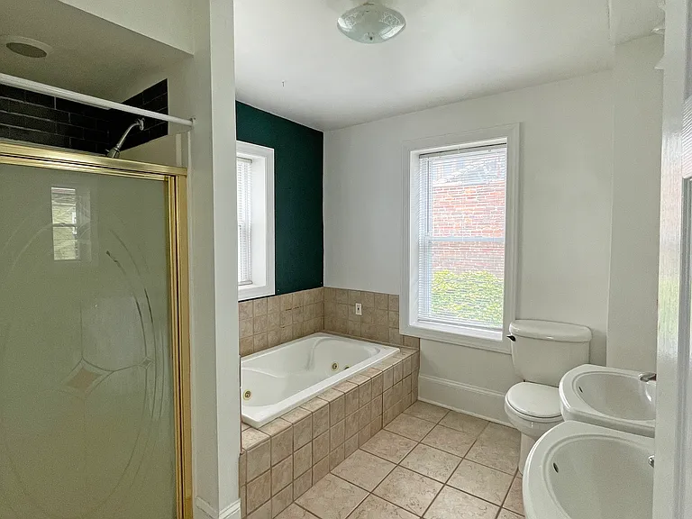 Large bathroom with two sinks, a Jacuzzi tub, and a separate shower