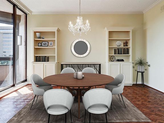 VIRTUALLY STAGED - The spacious dining area features a lovely chandelier and custom built-in cabinets and shelves.