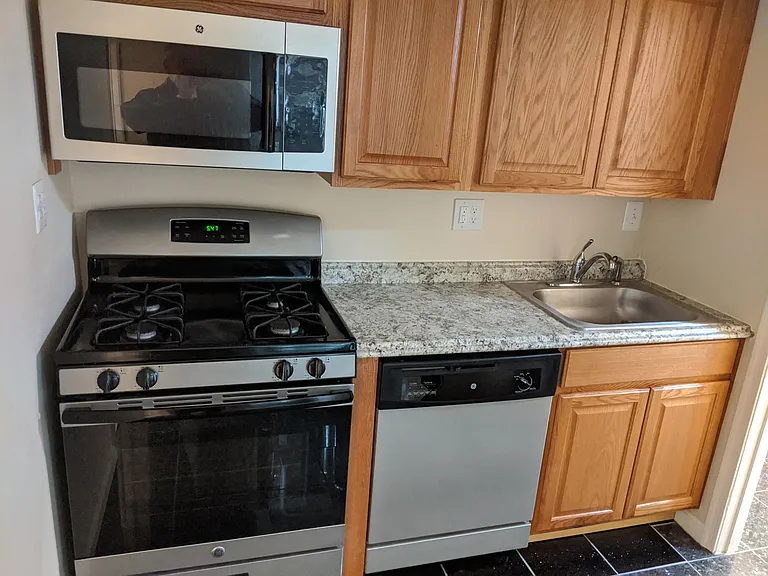 Kitchen with Cabinets, Sink, Full size Range, Large Microwave and full size Dishwasher