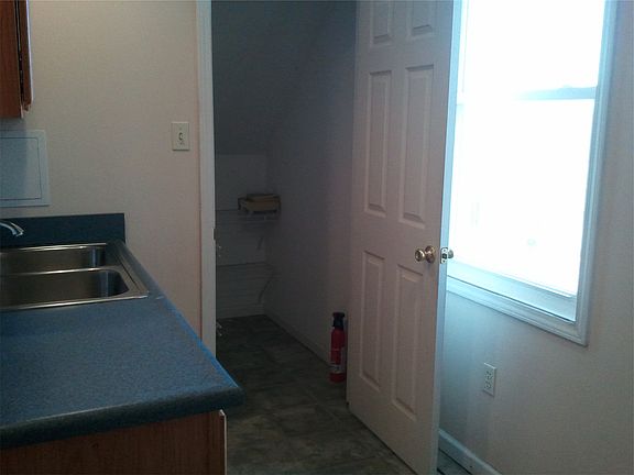 Storage closet, sink on left, window opposite sink