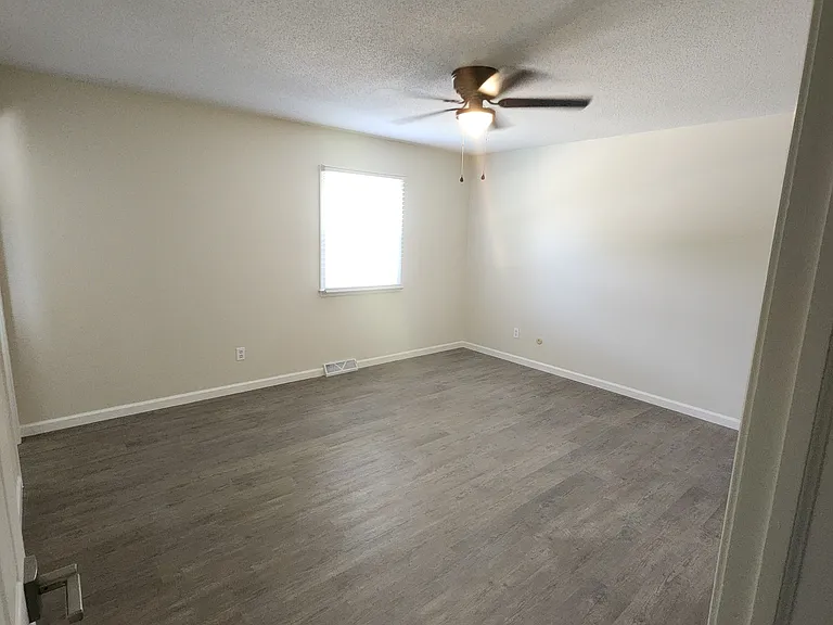 Master bedroom brand new ceiling fan (doorway view- closets to the right, master bathroom on lefthand side)