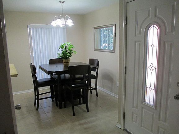 Separate dining room with brand new light fixture and window coverings.  Seller will leave matching mirror in dining room.  Notice the beautiful new front door.