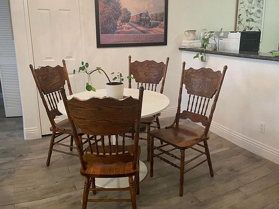 Dining area with matching set of chairs replacing mismatched set in other pictures.