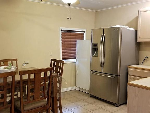 Another view of the kitchen with the breakfast area, more cabinets, and the SS frig is included (the freezer is not)