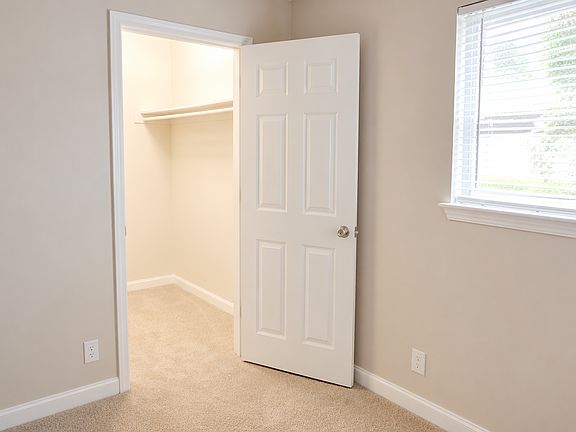 Walk in closet in primary bedroom