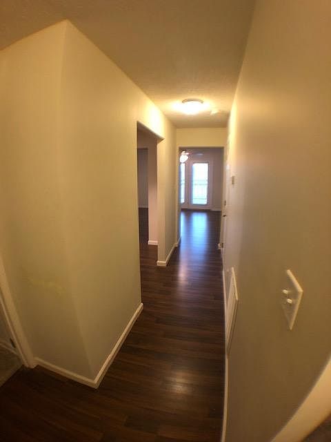 Entryway. The entire downstairs is a wood laminate for easy cleaning. The laundry room is the door to the left. Stairs are to the right.