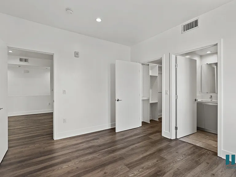 Bedroom with Bathroom, Walk-In Closet, and Vinyl Flooring