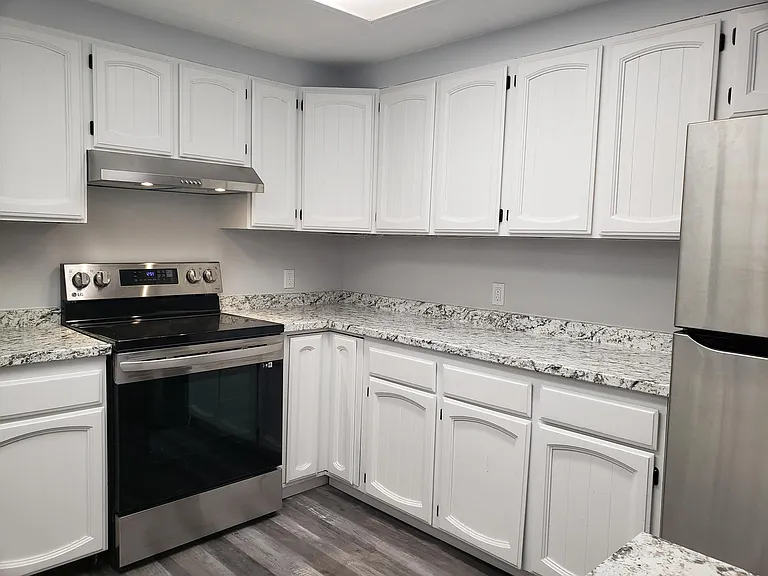 Fully renovated kitchen with new appliances, floors and refinished cabinets.