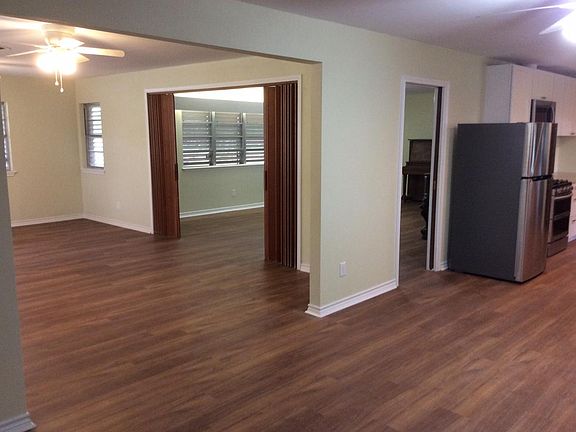 Den to the left with accordion doors leading to living room. Picture taken from the eating area of the kitchen