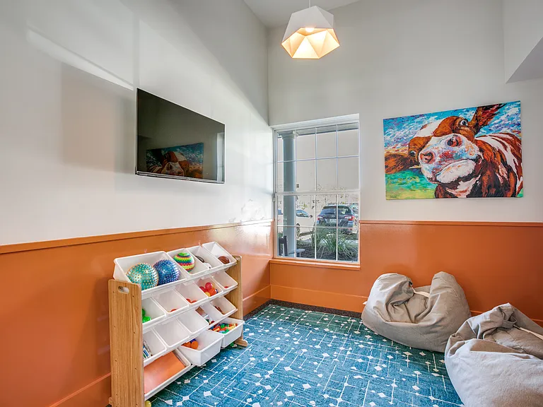 Chill Zone for Small Children in fitness area with book and tv.