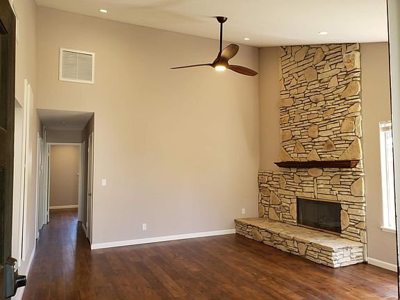 Living Room with gas fireplace, ceiling fan and LED lighting.