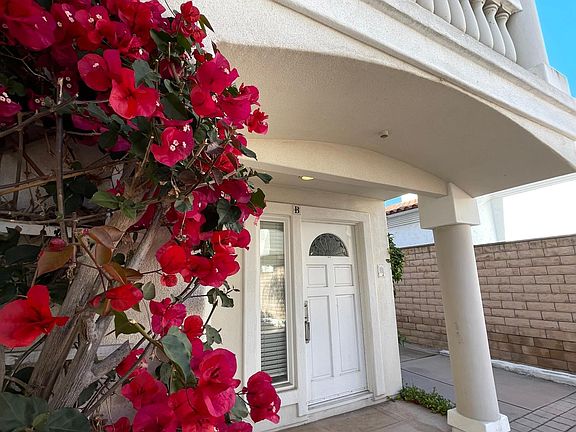 Red bougainvillea flowers on the side of front door welcoming your visit!