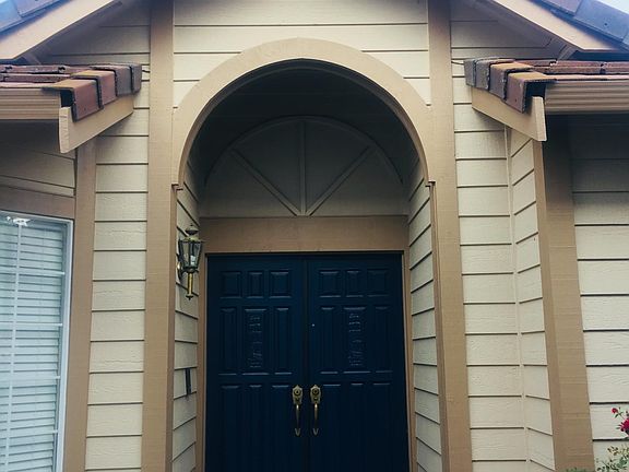 The front_ door is positioned_ on the side of the house. _