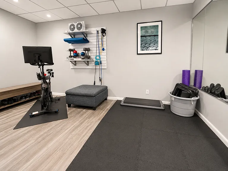 Basement includes home workout equipment and Peloton bike