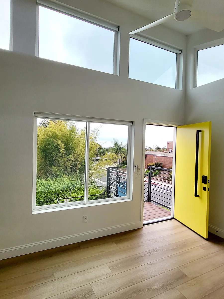 Living room with lots of ocean west facing windows. Tall vaulted ceilings. - 3659 Monroe St #1