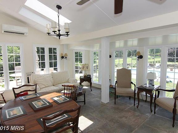 Fully enclosed sunroom overlooks pool