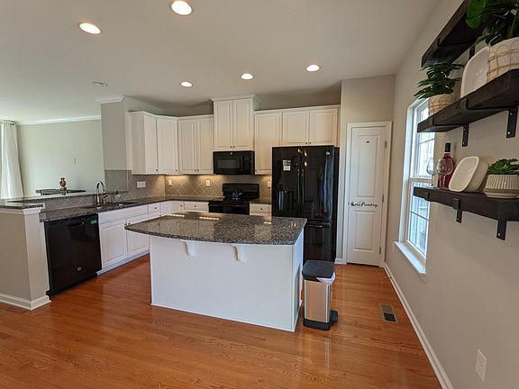White cabinets, granite counters, tile backsplash, GE appliances