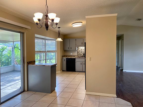 Dining area directly off the living room with open access to kitchen and back porch