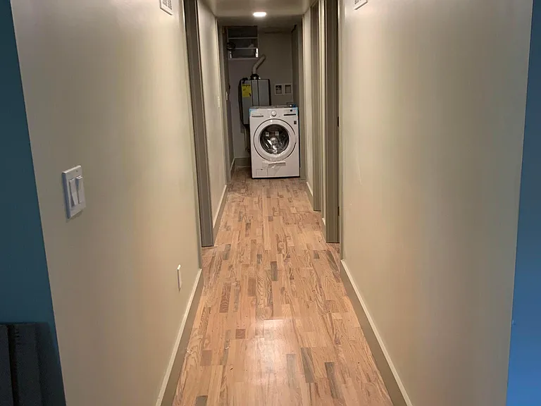 Hallway with 2 bedrooms and a bath on each side and laundry at the end - dryer has since been stacked on top of washer