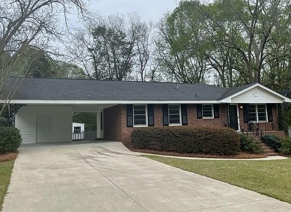 Carport holds 2 cars. Extra wide and long driveway for additional parking.