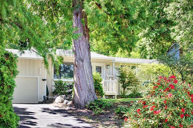 Beautiful setting with mature shrubs and trees. Home is set back from the street.