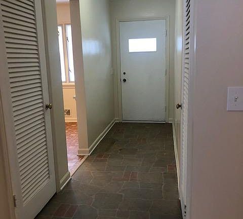 View from Living room to front door. Strorage to the left and coat closet to the right.