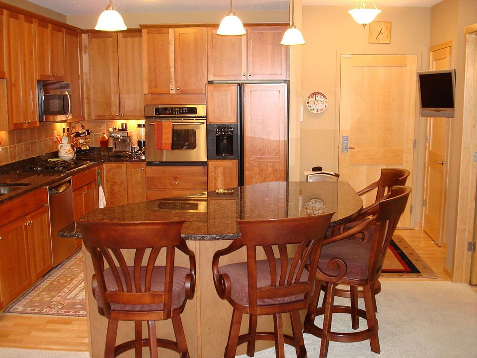 The gourmet kitchen has maple floors, granite countertops, and hardwood floors