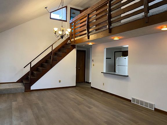 Living room with hardwood stairs and new flooring