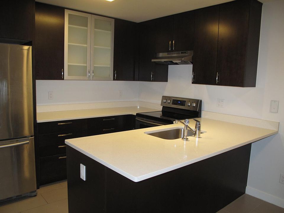 Modern style kitchen with quartz countertops and lots of sto