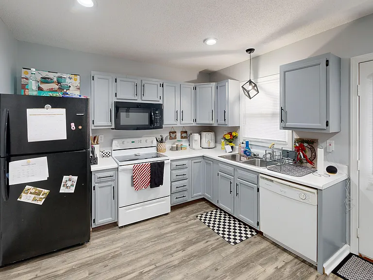 Another view of the kitchen and laundry closet with washer & dryer hookups. Photo is of a similar unit; available unit has the same floorplan. Washer & dryer not included; fixtures included, furniture and decor not included.