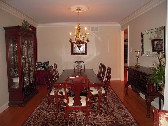 Formal Dining Room with custom crown molding and hardwood floors
