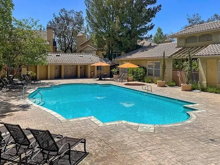 One of two community pools within the condo complex. Each pool has a hot tub, showers to the side. Pools are gated and residents receive electronic keys for access.